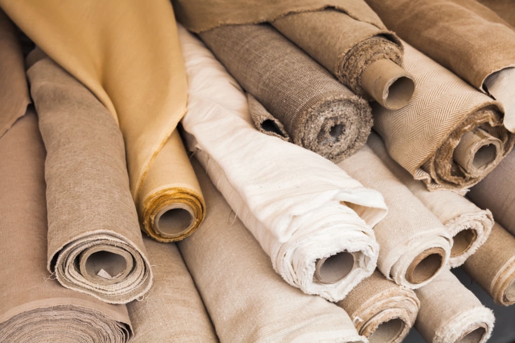 Rolls of  linen cloth lie on the market counter